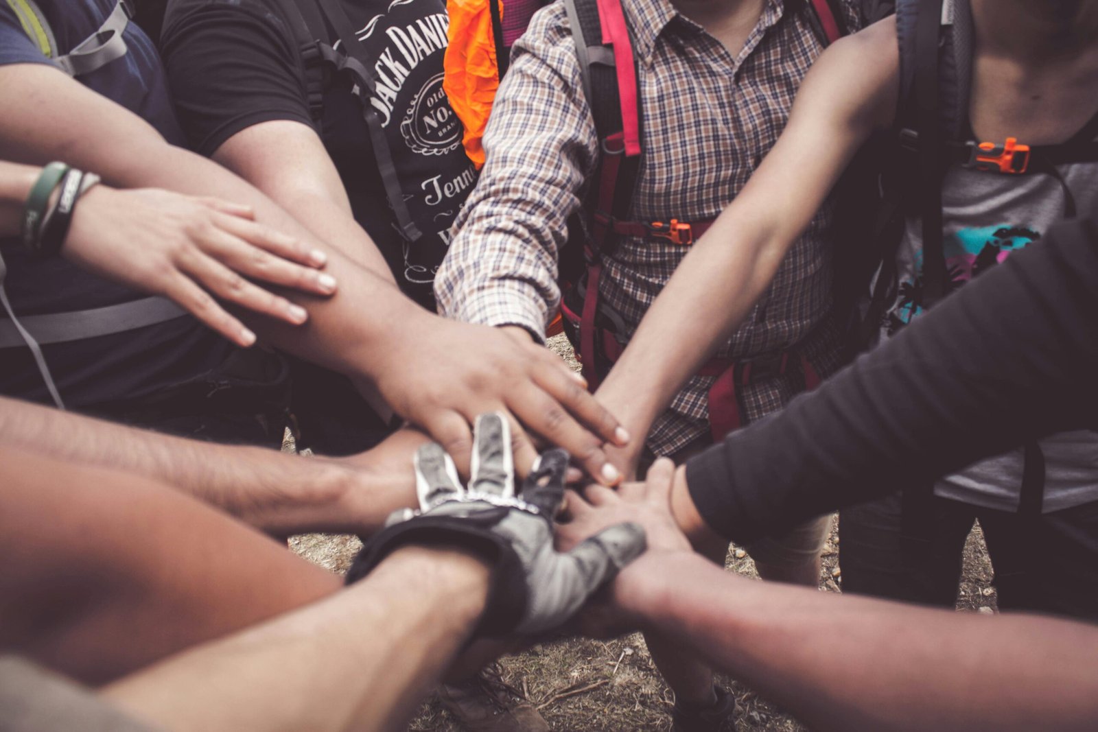About A group of diverse individuals join hands for teamwork in West Java, Indonesia.